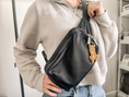 Load image into Gallery viewer, an image of the mini keychain on a cross body bag to show its versatility.