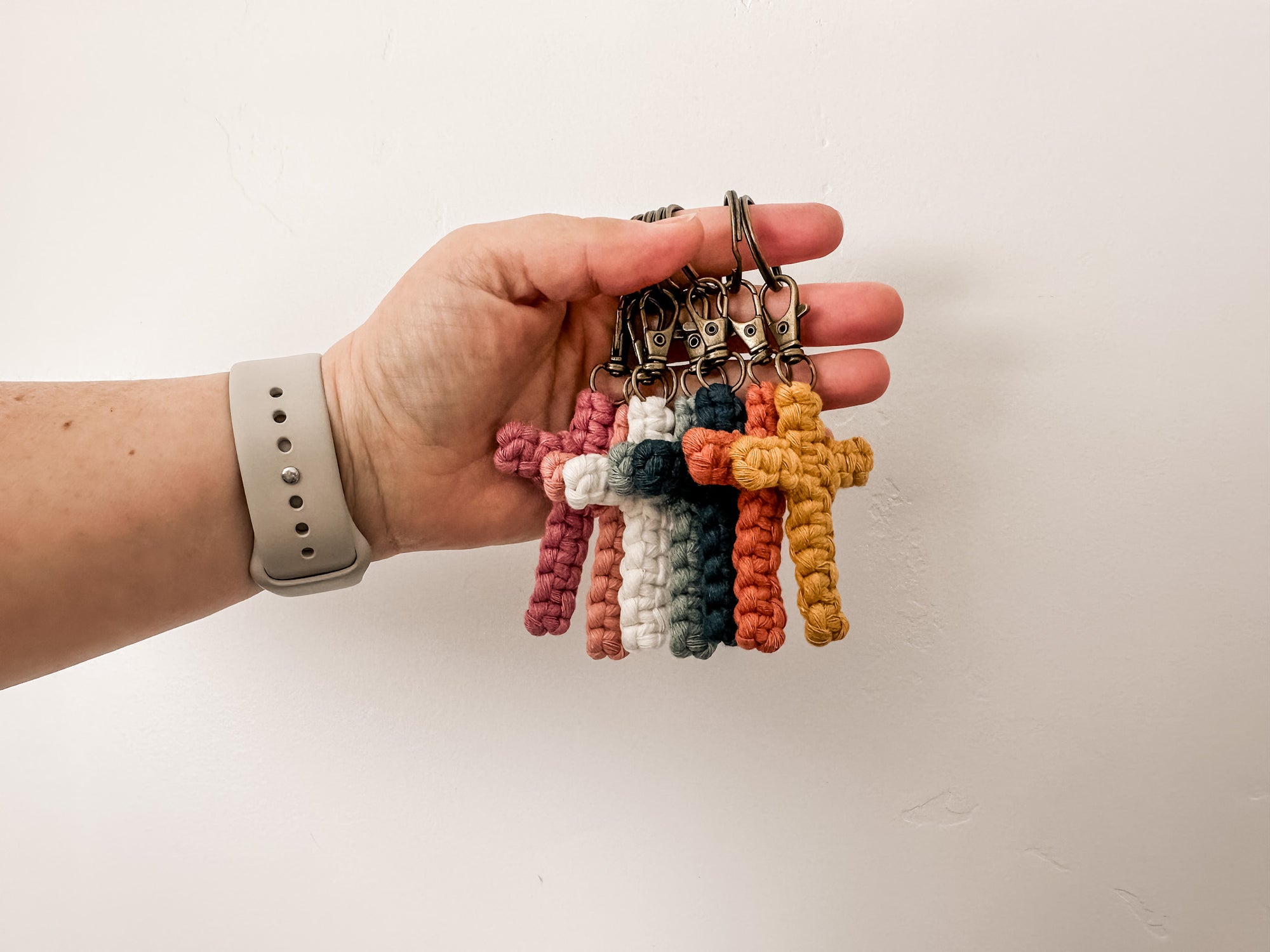 Faith-inspired cross keychains held by keyring to show off the bronze clasp.
